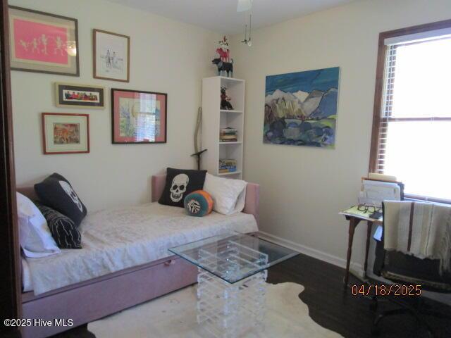 bedroom with wood finished floors and baseboards