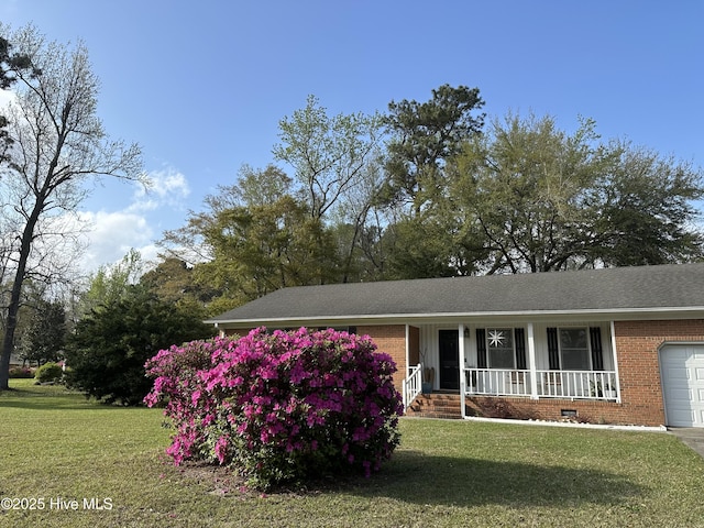 view of front of house with a garage, covered porch, brick siding, crawl space, and a front lawn