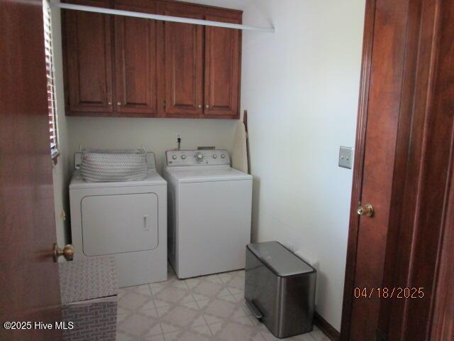 laundry area featuring cabinet space, independent washer and dryer, and light flooring
