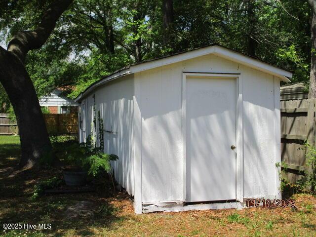 view of shed with fence