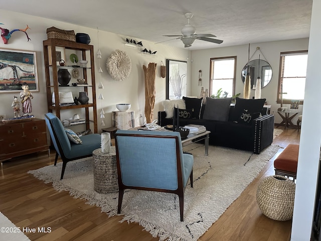 living area featuring a ceiling fan and wood finished floors