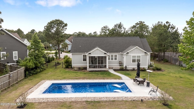 rear view of property with a sunroom, a patio, board and batten siding, and a shingled roof