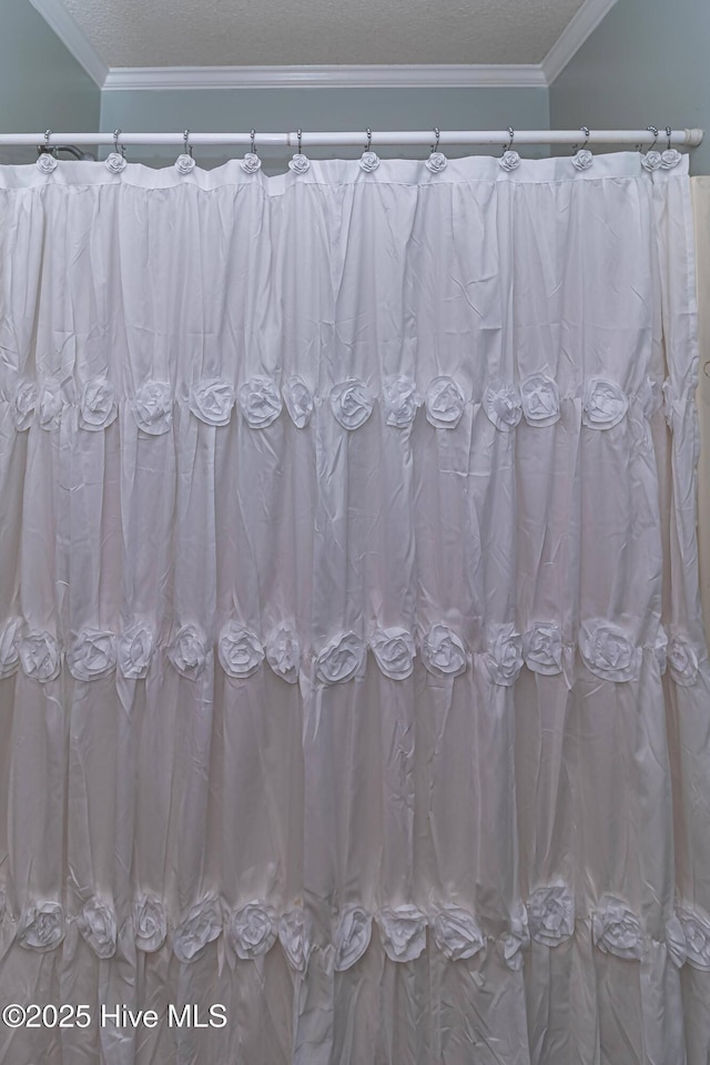 full bath featuring crown molding, a textured ceiling, and curtained shower