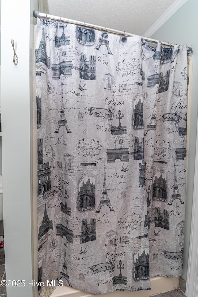 full bathroom with crown molding and a shower with shower curtain