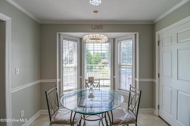 dining area with crown molding, baseboards, a textured ceiling, and a chandelier