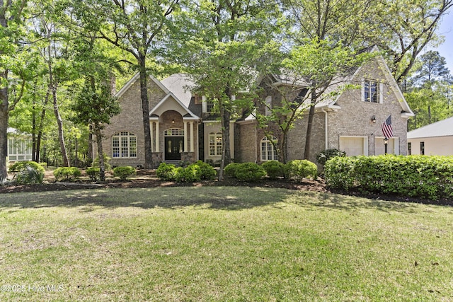 1626 Amberwood Dr SE, Bolivia, NC 28422 - view of front of property featuring brick siding, stone siding, and a front lawn