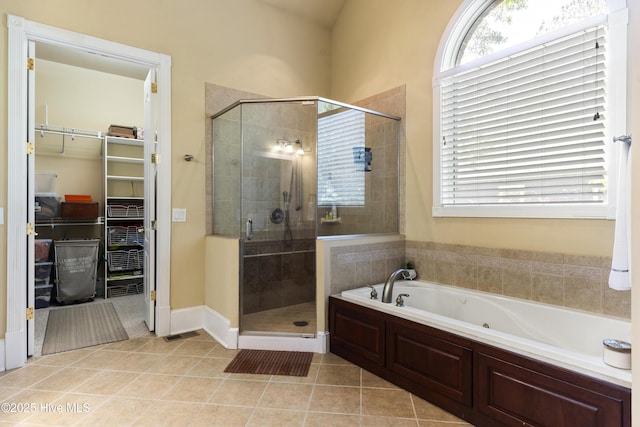 1626 Amberwood Dr SE, Bolivia, NC 28422 - bathroom featuring a walk in closet, a bath, a shower stall, and tile patterned floors