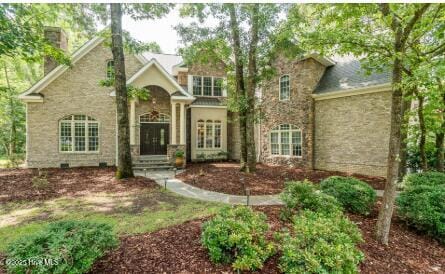 1626 Amberwood Dr SE, Bolivia, NC 28422 - view of front of house featuring a chimney and stone siding