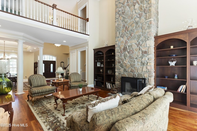 1626 Amberwood Dr SE, Bolivia, NC 28422 - living area with ornate columns, wood finished floors, ornamental molding, baseboards, and a fireplace