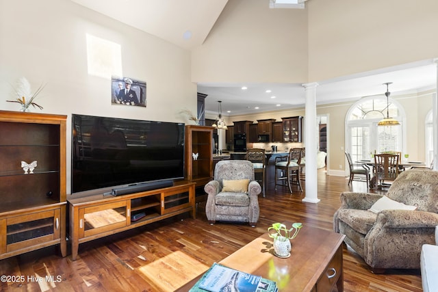 1626 Amberwood Dr SE, Bolivia, NC 28422 - living room with high vaulted ceiling, crown molding, dark wood finished floors, baseboards, and decorative columns