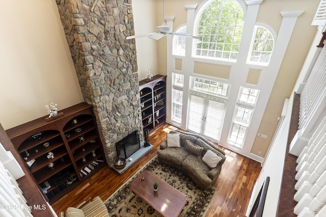 1626 Amberwood Dr SE, Bolivia, NC 28422 - living room featuring wood finished floors, a towering ceiling, a fireplace, and ceiling fan