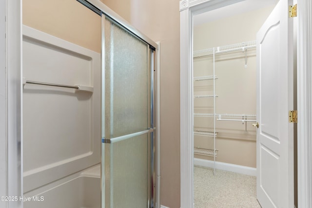 1626 Amberwood Dr SE, Bolivia, NC 28422 - full bathroom featuring baseboards, a spacious closet, and a stall shower