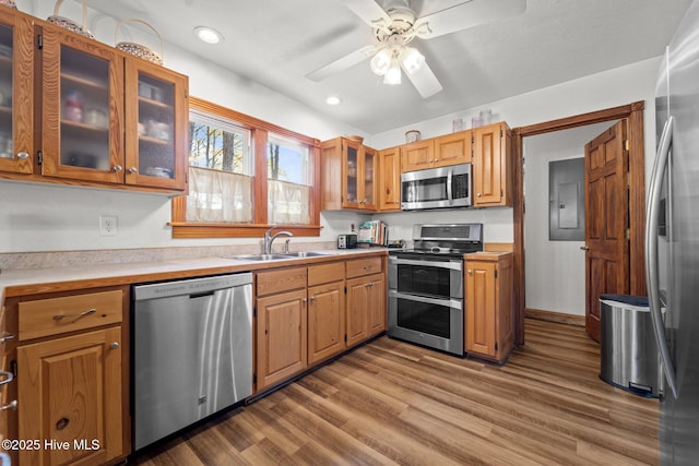 121 Pinewood Acres Dr, Powells Point, NC 27966 - kitchen with stainless steel appliances, light countertops, wood finished floors, a ceiling fan, and a sink