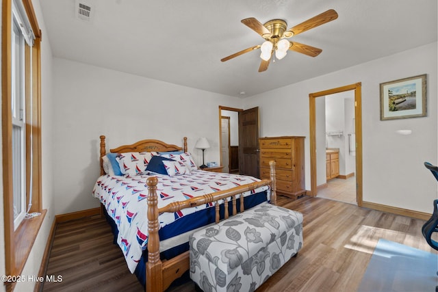 121 Pinewood Acres Dr, Powells Point, NC 27966 - bedroom featuring light wood-type flooring, baseboards, ensuite bathroom, and visible vents