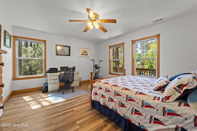 121 Pinewood Acres Dr, Powells Point, NC 27966 - bedroom with baseboards, wood finished floors, multiple windows, and visible vents