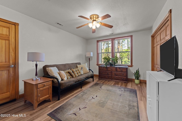121 Pinewood Acres Dr, Powells Point, NC 27966 - living area featuring light wood-type flooring, baseboards, a ceiling fan, and visible vents