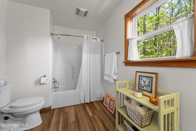 121 Pinewood Acres Dr, Powells Point, NC 27966 - full bathroom with wood finished floors, visible vents, toilet, and shower / bath combination with curtain