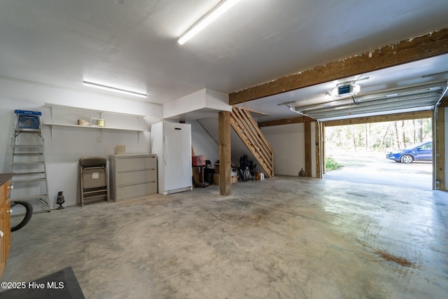 121 Pinewood Acres Dr, Powells Point, NC 27966 - garage featuring freestanding refrigerator and a garage door opener