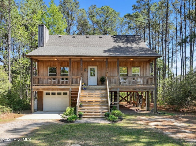 121 Pinewood Acres Dr, Powells Point, NC 27966 - view of front of home with driveway, covered porch, stairs, and roof with shingles