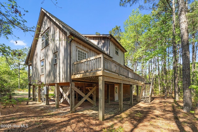 121 Pinewood Acres Dr, Powells Point, NC 27966 - rear view of house featuring stairway and a wooden deck
