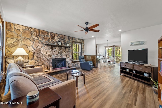 121 Pinewood Acres Dr, Powells Point, NC 27966 - living area with a ceiling fan, wood finished floors, a textured ceiling, a fireplace, and recessed lighting