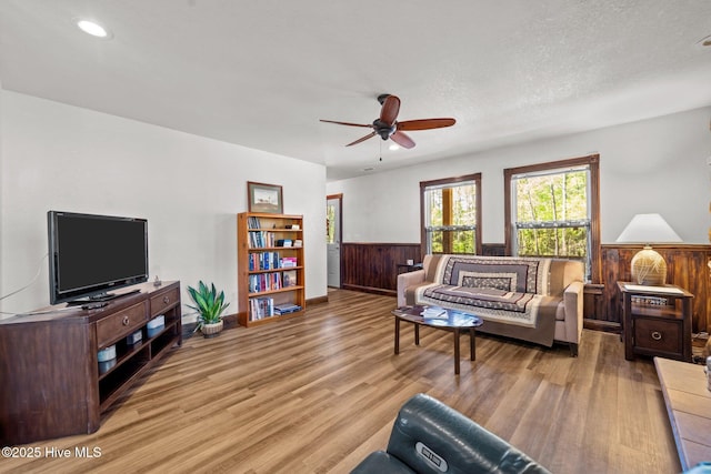 121 Pinewood Acres Dr, Powells Point, NC 27966 - living area with recessed lighting, a wainscoted wall, wood finished floors, a ceiling fan, and baseboards