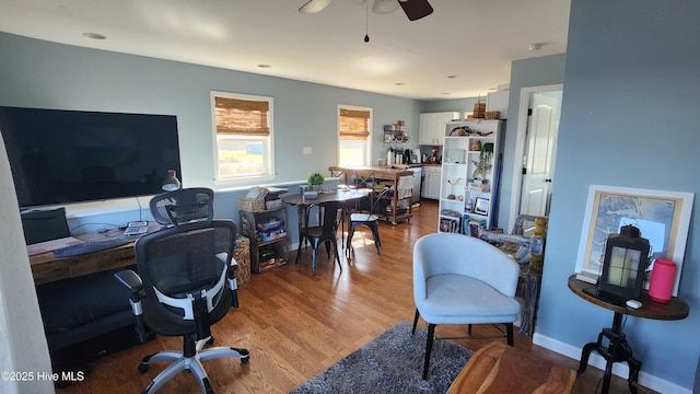 home office with ceiling fan and wood finished floors