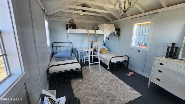 bedroom with lofted ceiling with beams and multiple windows