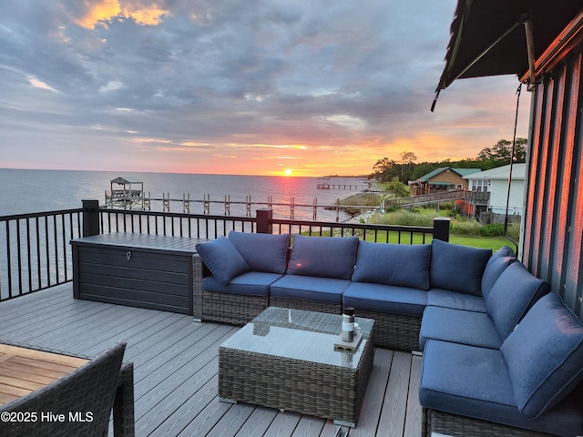 wooden deck featuring an outdoor hangout area and a water view