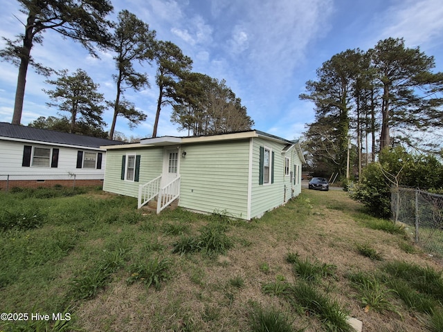 view of front of home featuring entry steps and fence