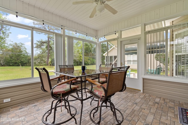 sunroom / solarium featuring ceiling fan, outdoor dining space, and visible vents