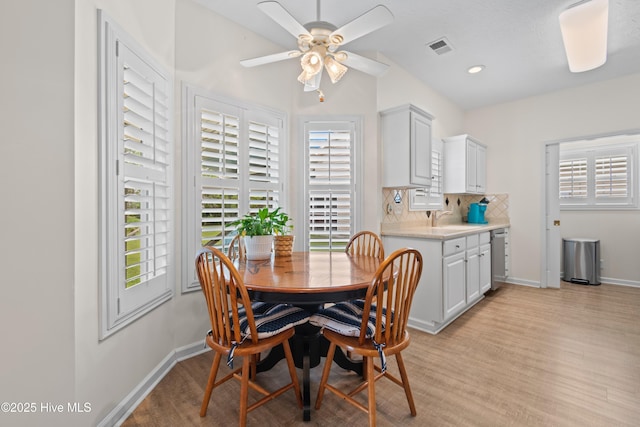 dining area with visible vents, plenty of natural light, light wood finished floors, and a ceiling fan