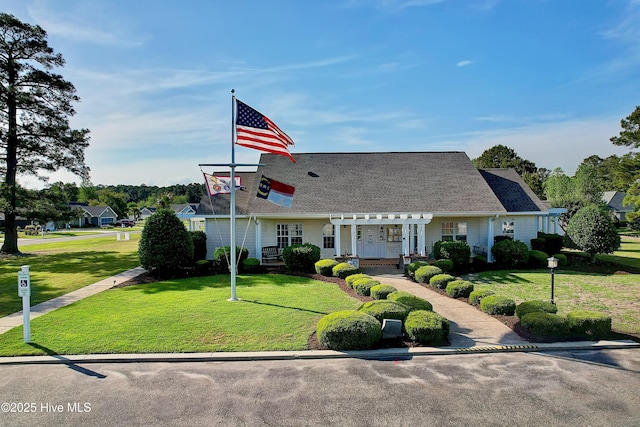 view of front of home with roof with shingles and a front lawn