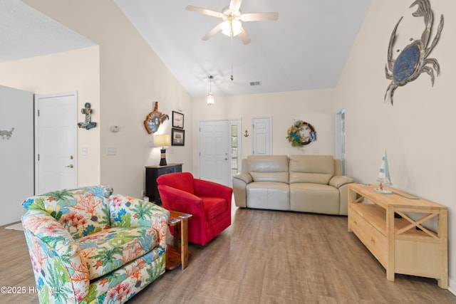 living room featuring wood finished floors, ceiling fan, high vaulted ceiling, and visible vents