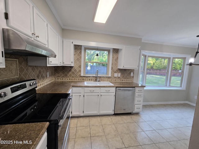 kitchen featuring under cabinet range hood, backsplash, dark countertops, a sink, and appliances with stainless steel finishes