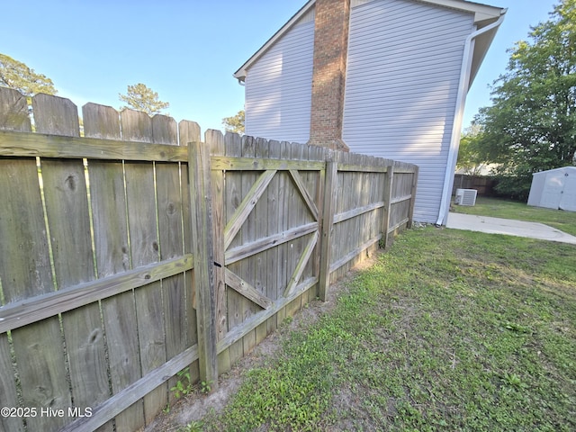 exterior space featuring fence, a patio, a gate, and central AC unit