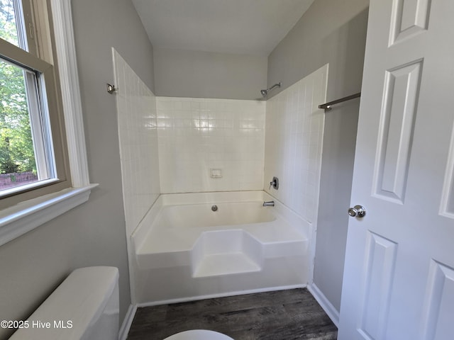 full bath with baseboards, wood finished floors, and toilet
