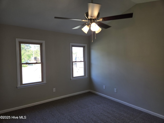 unfurnished room with dark carpet, baseboards, and ceiling fan
