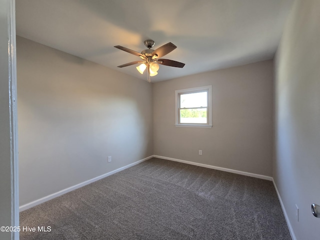 spare room featuring ceiling fan, baseboards, and dark colored carpet
