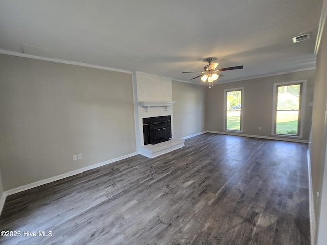 unfurnished living room featuring dark wood-style floors, a ceiling fan, crown molding, baseboards, and visible vents