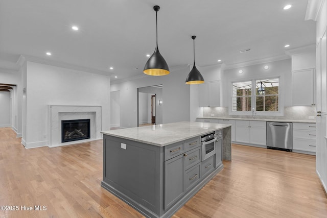 kitchen featuring crown molding, appliances with stainless steel finishes, gray cabinets, white cabinetry, and tasteful backsplash