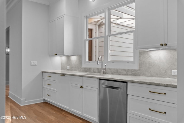 kitchen with white cabinets, light wood-type flooring, a sink, and dishwasher