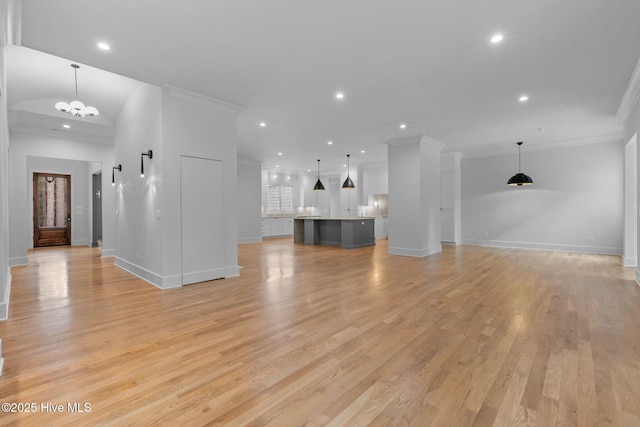 unfurnished living room featuring crown molding, recessed lighting, baseboards, and light wood-type flooring