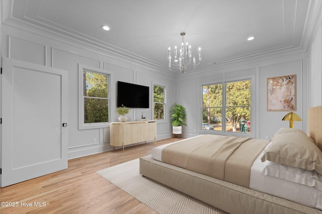 bedroom with an inviting chandelier, ornamental molding, a decorative wall, and recessed lighting
