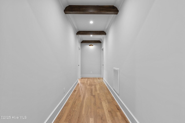hall with visible vents, beam ceiling, baseboards, recessed lighting, and light wood-style flooring
