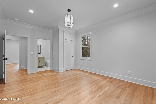unfurnished dining area featuring crown molding, baseboards, recessed lighting, and light wood finished floors