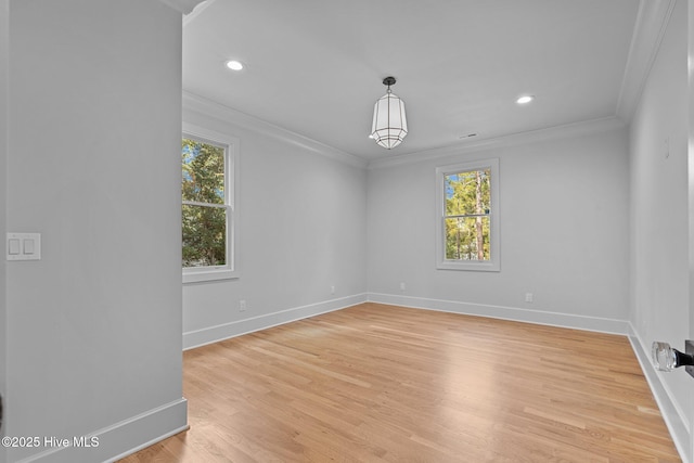 empty room featuring baseboards, ornamental molding, and a healthy amount of sunlight