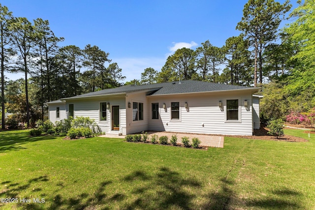 back of property with a yard