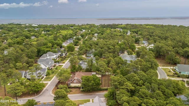 bird's eye view with a wooded view, a residential view, and a water view
