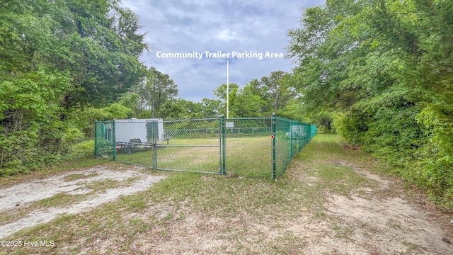 view of gate featuring a yard and fence